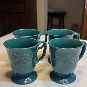 A set of (4) Pioneer Woman 14oz  teal Cowgirl lace  mugs.